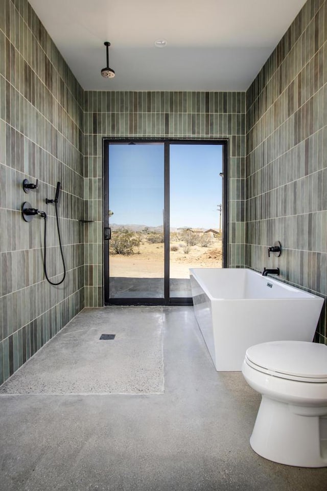 bathroom with toilet, tile walls, and independent shower and bath