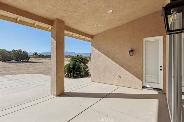 view of patio / terrace featuring a mountain view