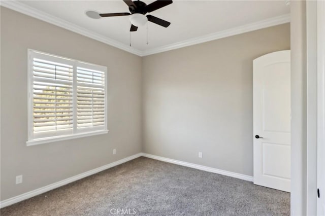 carpeted spare room with ceiling fan and crown molding