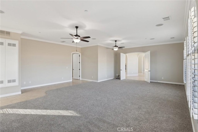 carpeted spare room featuring ceiling fan and crown molding