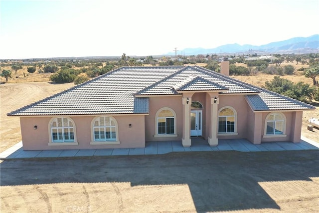 view of front facade with a mountain view and a patio