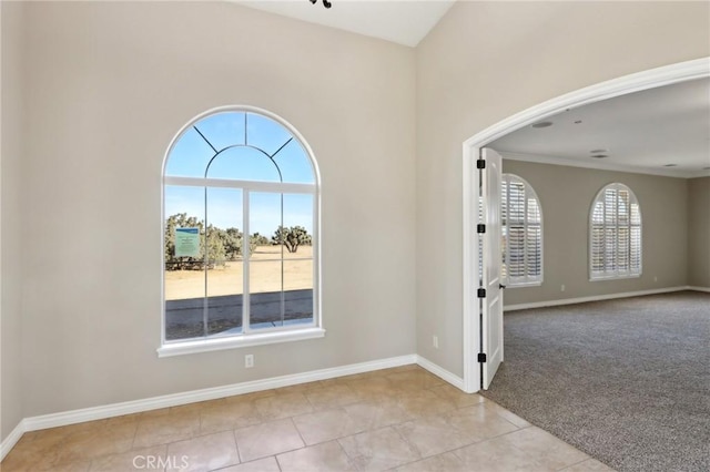 spare room with a healthy amount of sunlight and light colored carpet