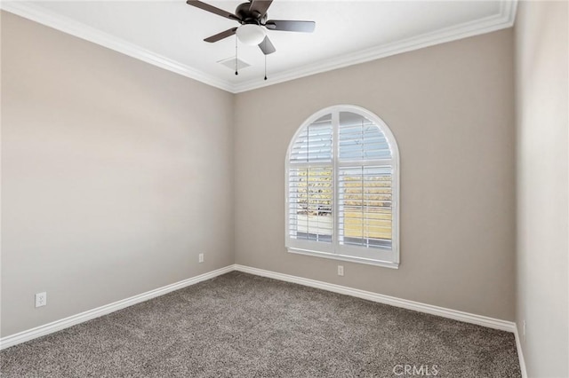 carpeted spare room with ceiling fan and ornamental molding