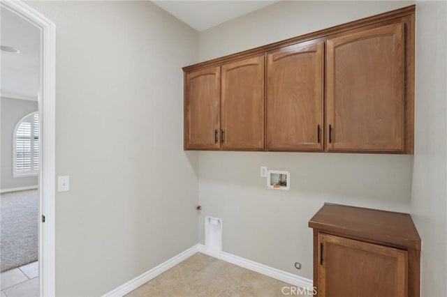 laundry area featuring cabinets, electric dryer hookup, gas dryer hookup, and hookup for a washing machine