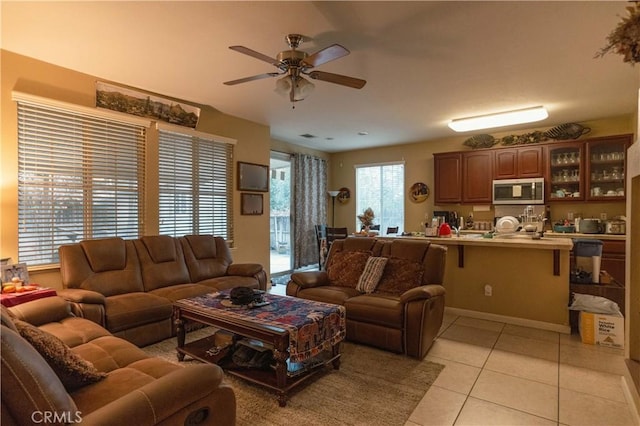 living room featuring ceiling fan and light tile patterned floors