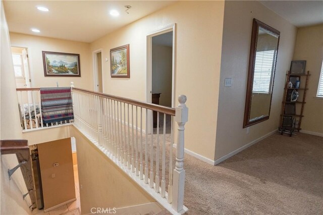 hall featuring light carpet