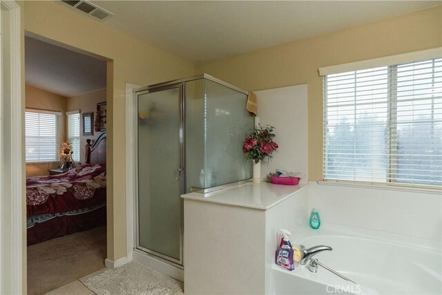 bathroom with shower with separate bathtub