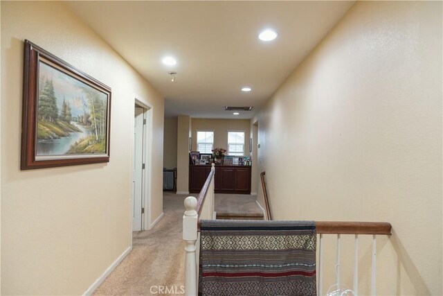 hallway with light carpet