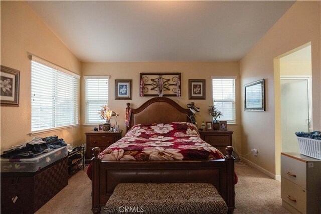 carpeted bedroom featuring lofted ceiling