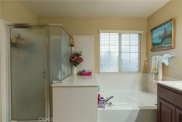 bathroom featuring vanity and shower with separate bathtub