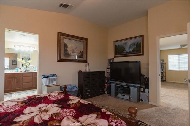 bedroom featuring connected bathroom, vaulted ceiling, and carpet flooring