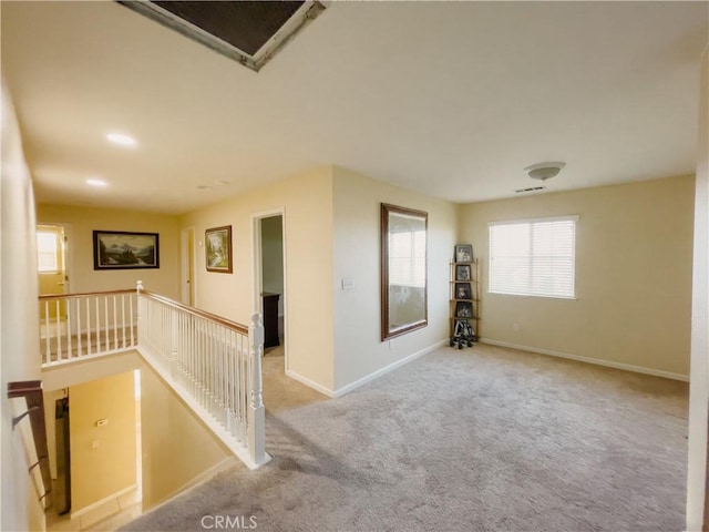 unfurnished room featuring carpet floors, visible vents, and baseboards