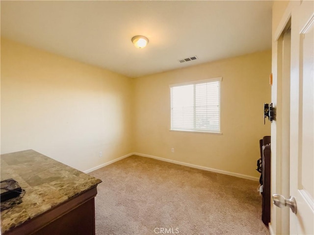 unfurnished room with light carpet, baseboards, and visible vents