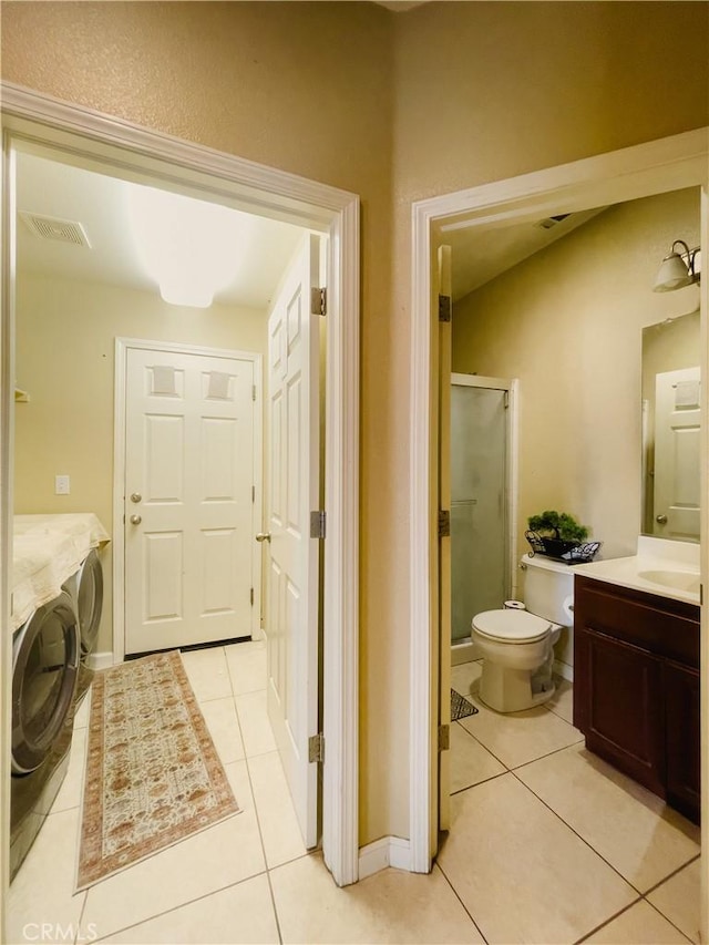 full bath featuring a shower stall, tile patterned flooring, vanity, and washer and dryer