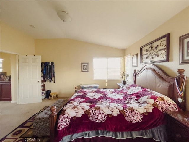 bedroom featuring carpet floors and lofted ceiling