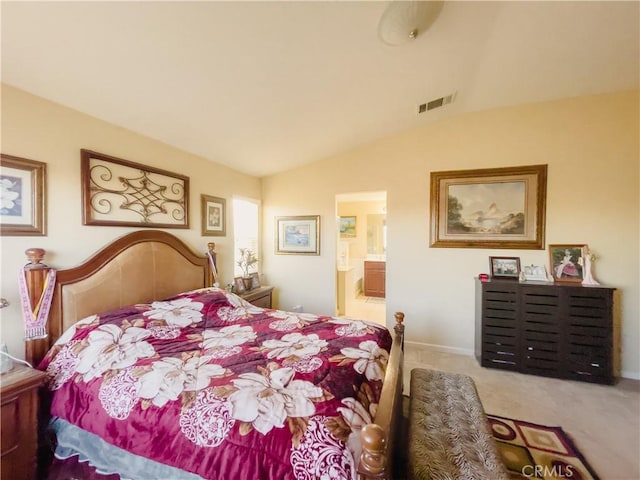 bedroom with lofted ceiling, carpet floors, ensuite bath, and visible vents