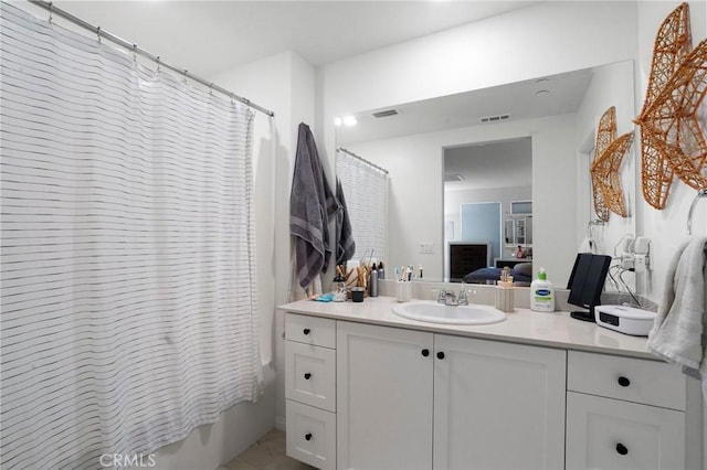 bathroom featuring vanity and shower / bath combination with curtain