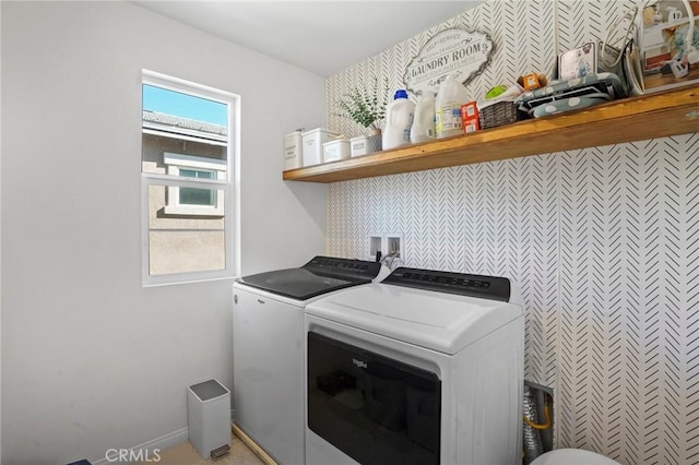 clothes washing area with washing machine and dryer