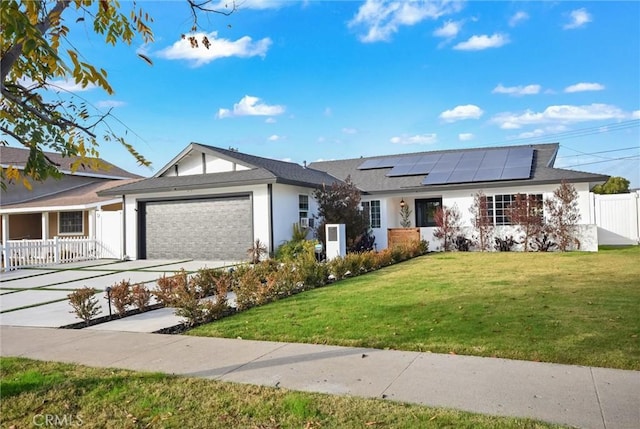 ranch-style house with a front lawn, solar panels, and a garage