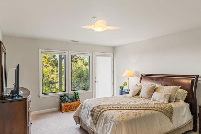 carpeted bedroom featuring multiple windows