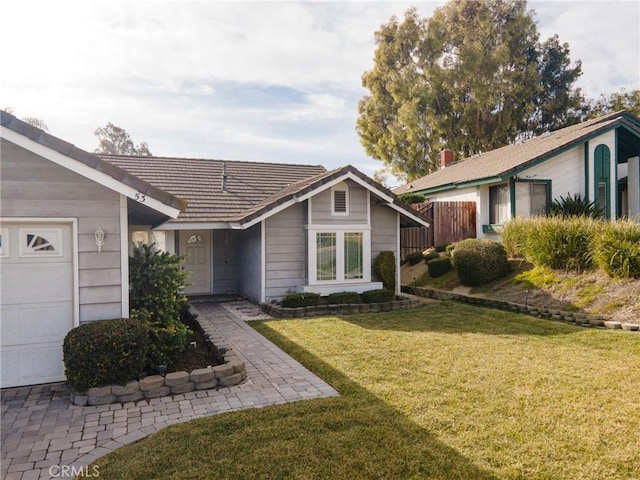 view of front of property with a front yard and a garage