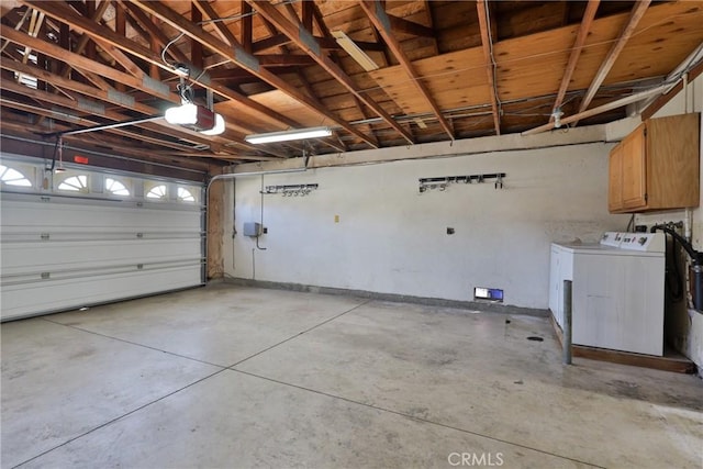 garage with a garage door opener and washing machine and clothes dryer