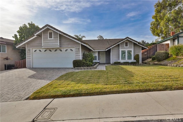 single story home featuring a front lawn and a garage