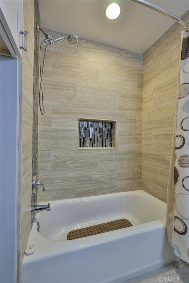 bathroom featuring shower / tub combo with curtain