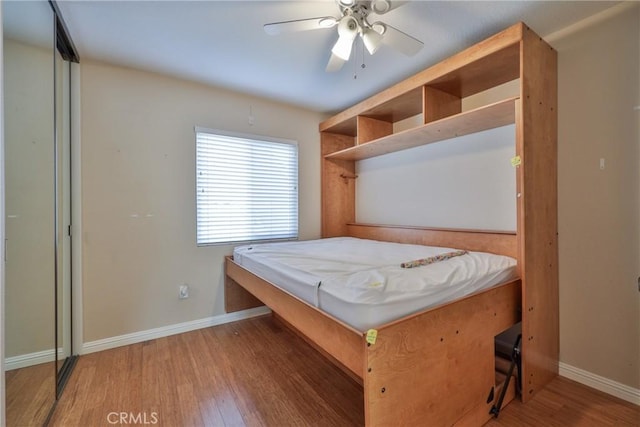 unfurnished bedroom featuring ceiling fan and dark hardwood / wood-style flooring