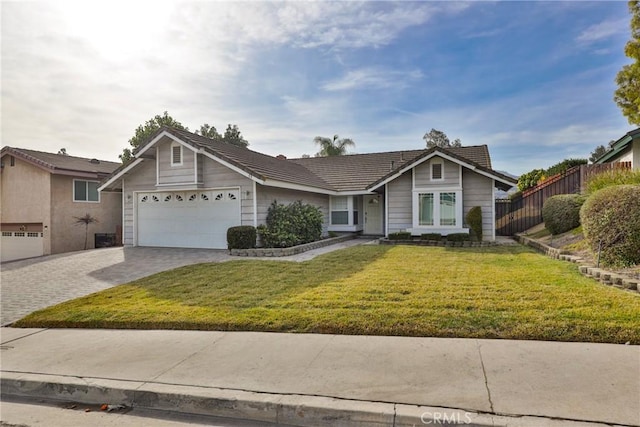 ranch-style home with a front lawn and a garage