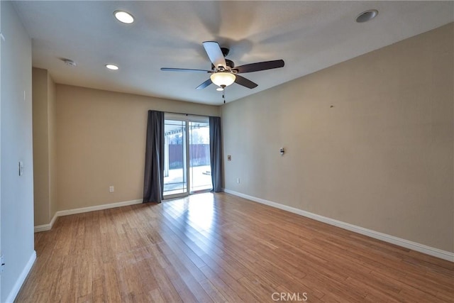 spare room with light wood-type flooring and ceiling fan