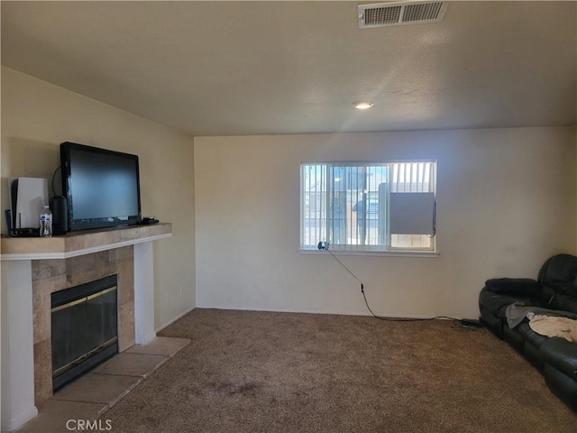 unfurnished living room with visible vents, a fireplace, and carpet floors