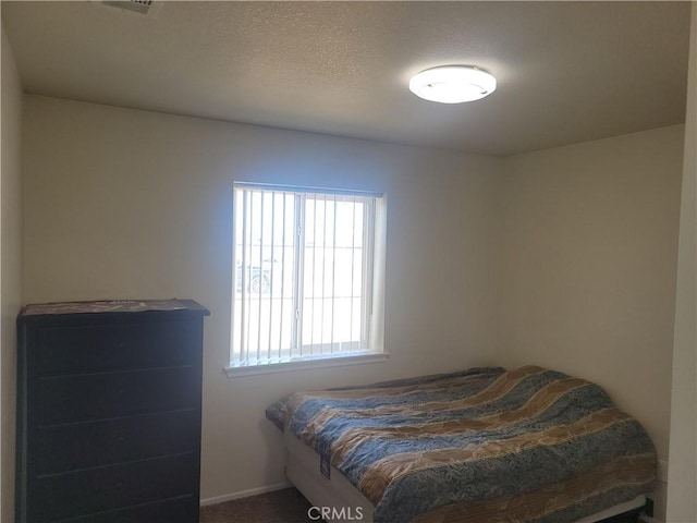 bedroom featuring a textured ceiling