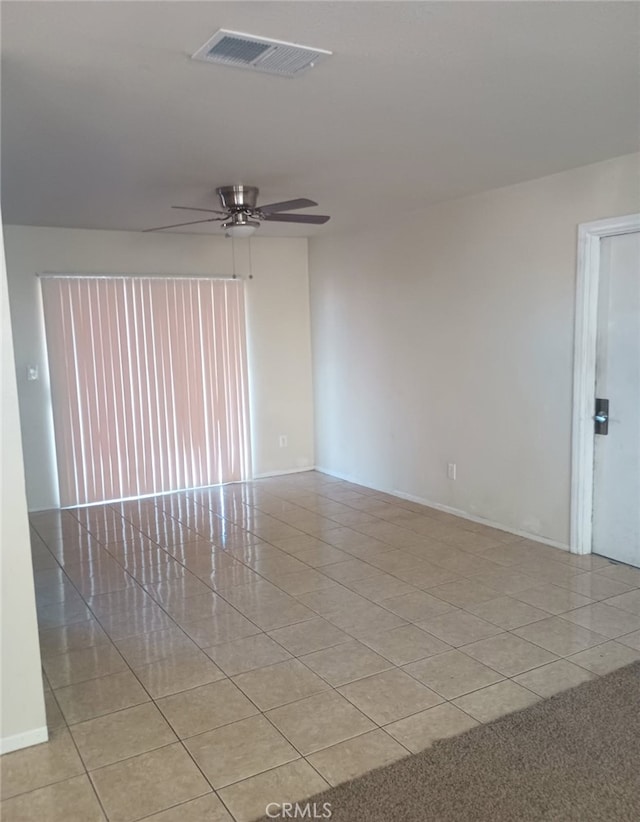 unfurnished room featuring ceiling fan, visible vents, and light tile patterned flooring