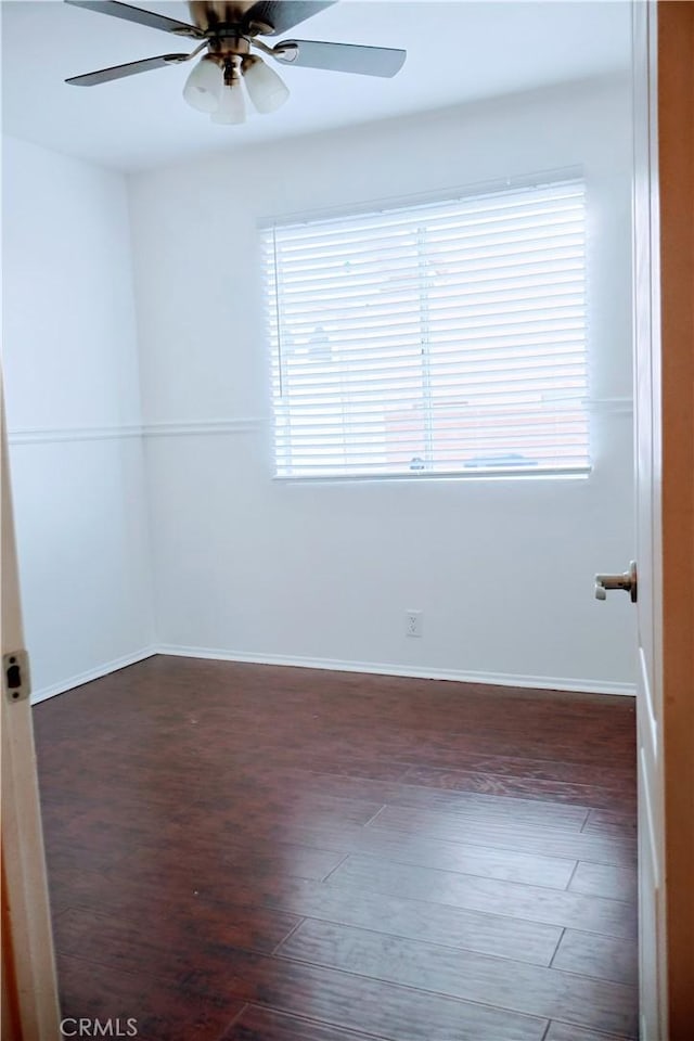 unfurnished room with dark wood-type flooring and ceiling fan