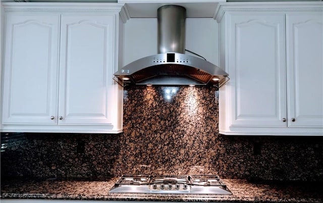 details with ventilation hood, tasteful backsplash, white cabinets, and dark stone counters