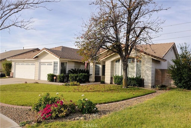 single story home featuring a garage and a front yard