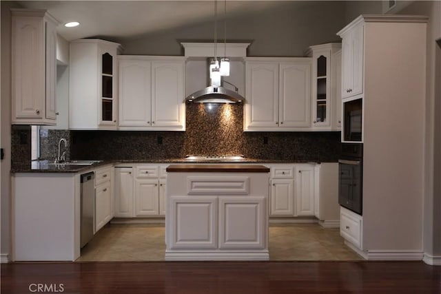 kitchen featuring wall chimney exhaust hood, lofted ceiling, sink, black appliances, and white cabinets