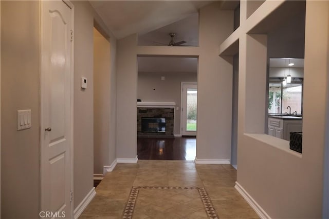 hall with lofted ceiling and sink