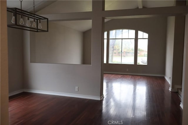 interior space featuring dark wood-type flooring and vaulted ceiling