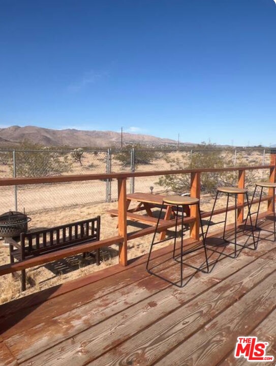 deck featuring a rural view and a mountain view