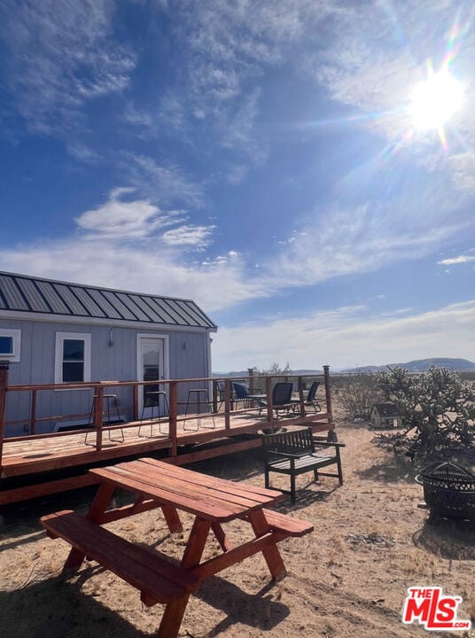 view of yard with a deck and a fire pit