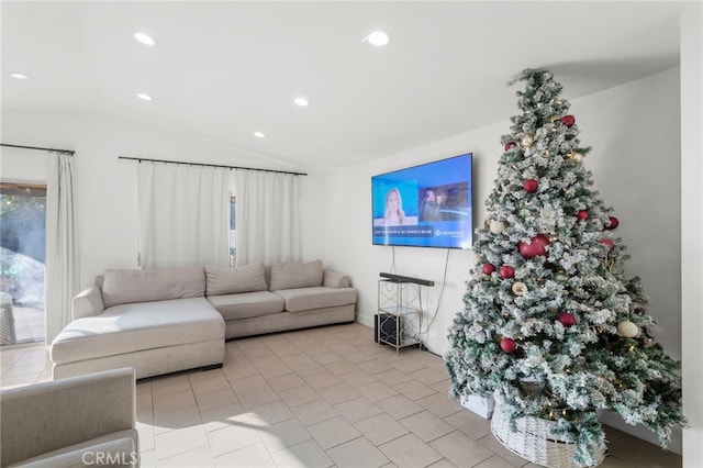 living room featuring light tile patterned floors and vaulted ceiling