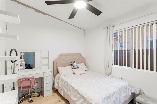 bedroom with ceiling fan and light hardwood / wood-style flooring