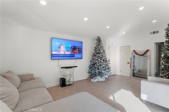 living room featuring lofted ceiling and light tile patterned flooring