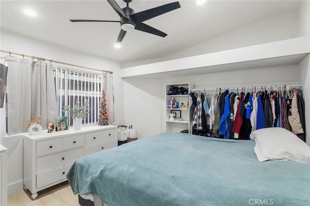 bedroom with ceiling fan, light hardwood / wood-style flooring, and lofted ceiling