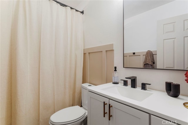 bathroom with toilet and vanity