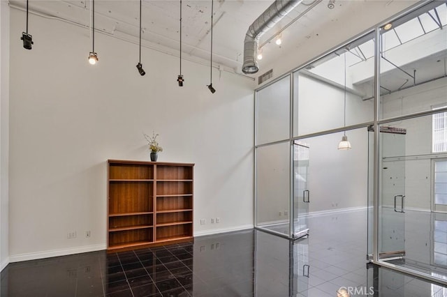 interior space with a high ceiling and tile patterned floors