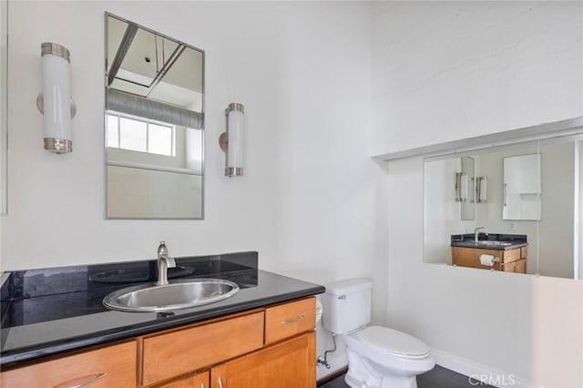 bathroom with toilet and vanity