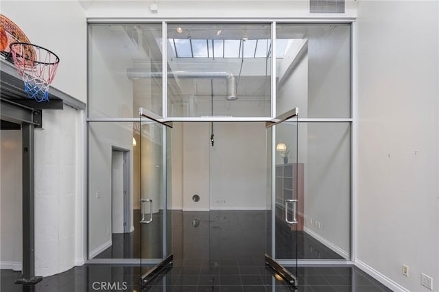 bathroom featuring a high ceiling